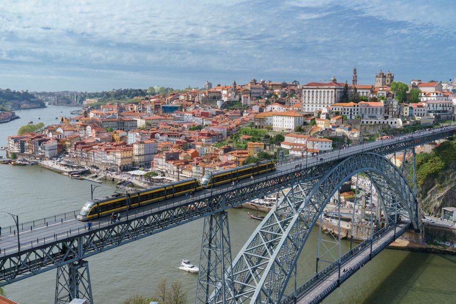 Panoramic view of Porto and Dom Luís I Bridge with yellow train