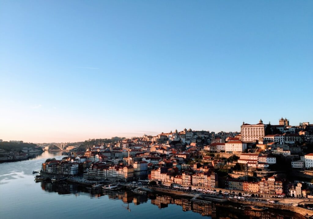 Sunlit Porto Ribeira district along the Douro River at golden hour
