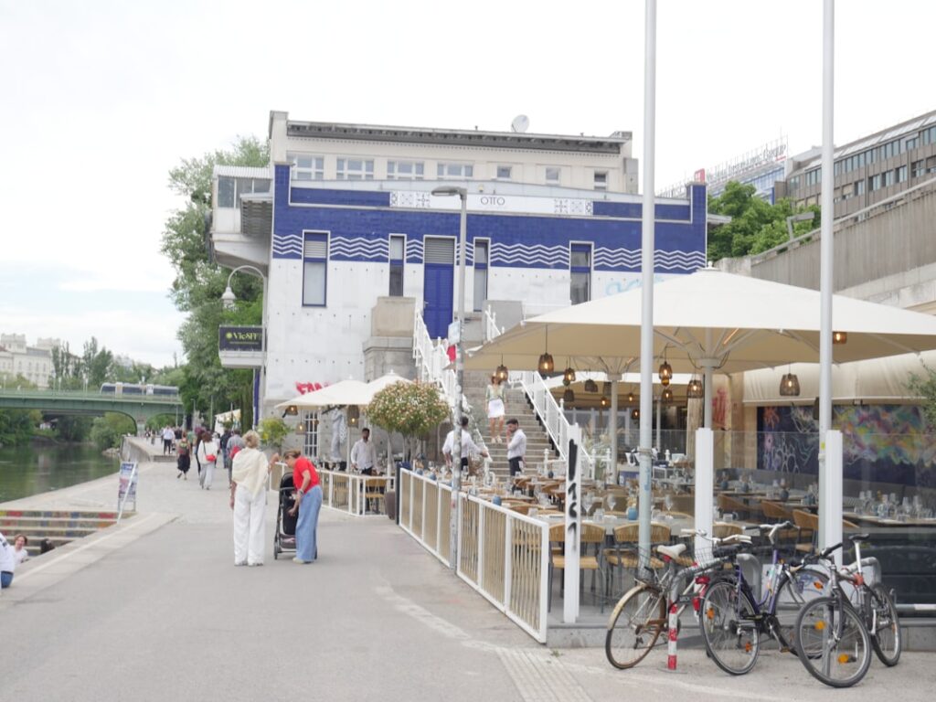 Outdoor riverside cafe with umbrellas and parked bicycles in Porto
