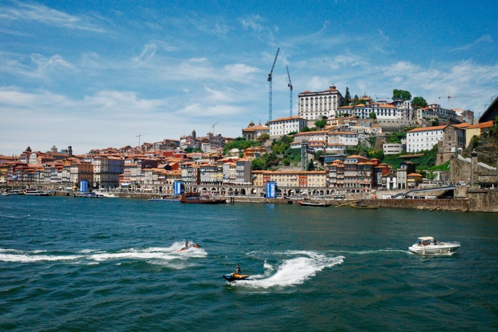 Jet skis and boats on the Douro River with Porto Ribeira waterfront