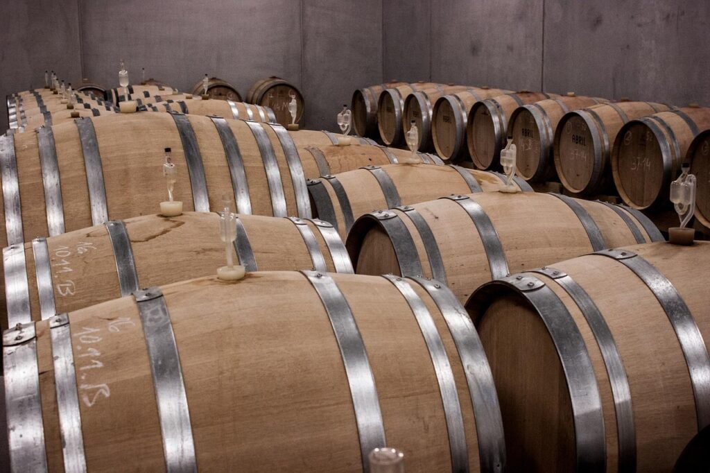 Rows of oak barrels aging port wine in a Porto cellar