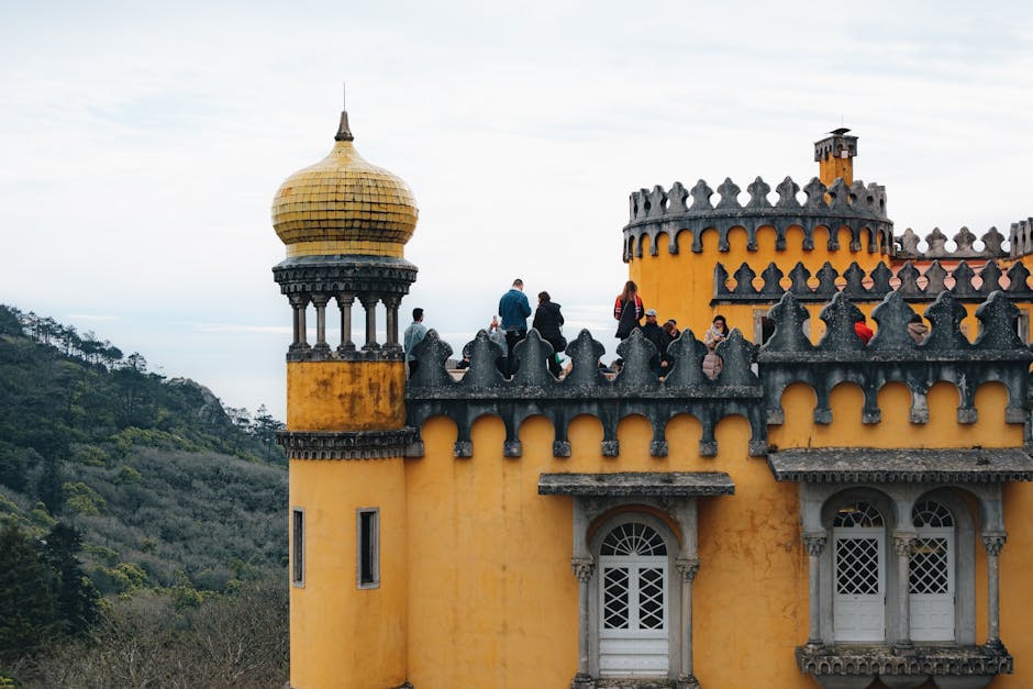 Visitors looking out from a viewpoint at Pena Palace