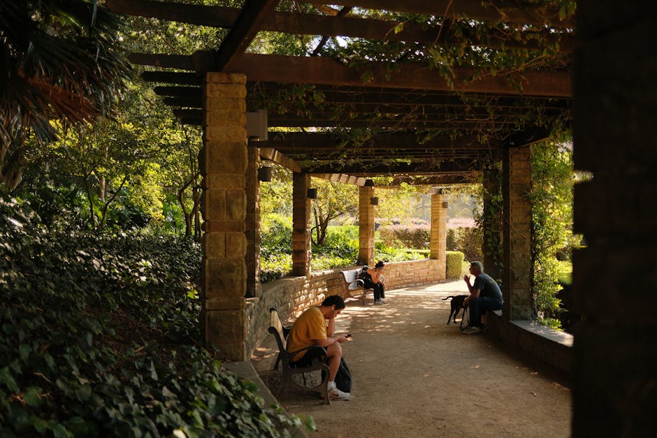 Stone pathway in the botanical garden and students reading on benches