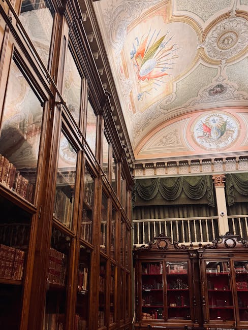Ornate ceiling and historic bookcases inside the Biblioteca Joanina
