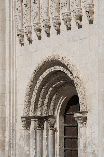 Exterior of Coimbra's Old Cathedral with sculpted capitals
