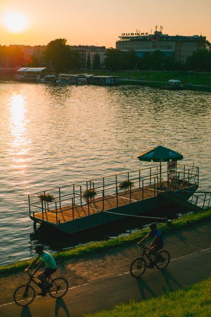 Vistula river bike path with green trees and cyclists