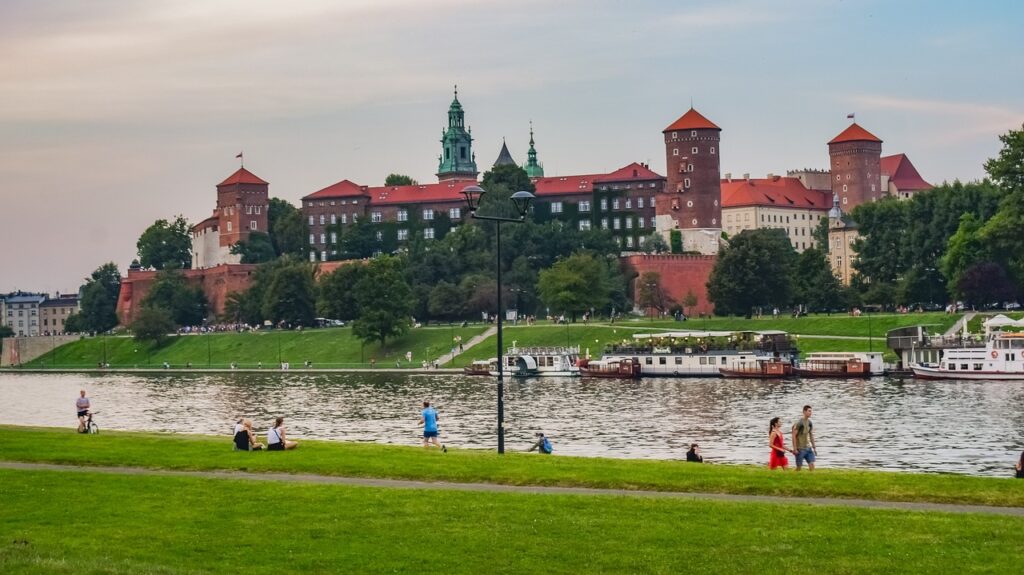 Wawel Castle riverside view with cyclists on the Vistula bank