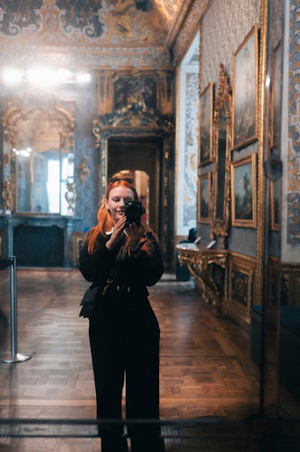 Visitor photographing an ornate hallway inside the Royal Castle