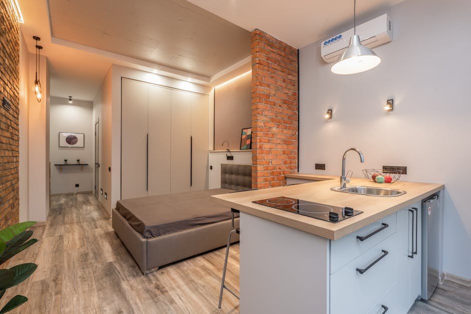 Small studio apartment interior with compact kitchen in Żoliborz