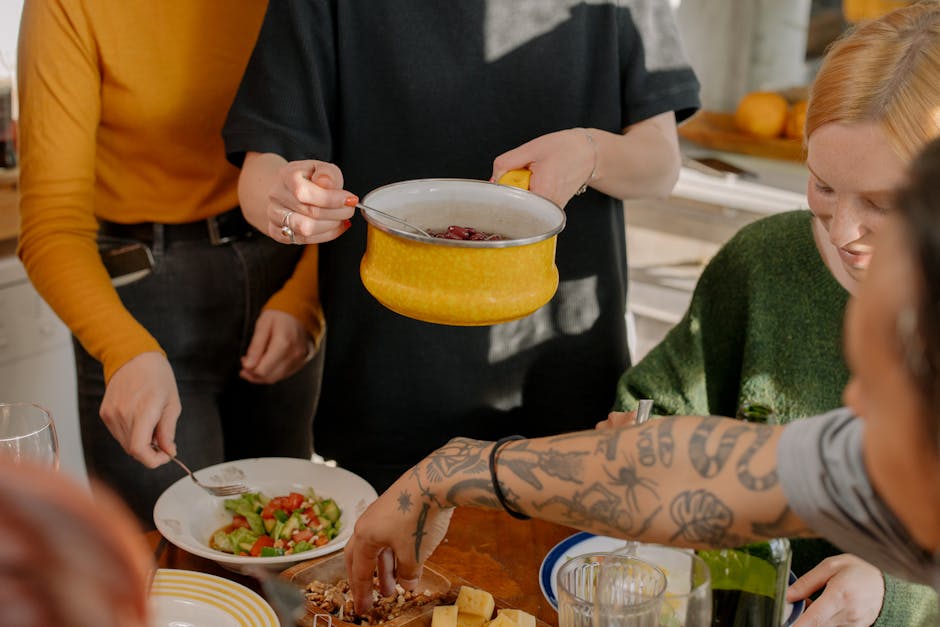 Group of travelers sharing a meal in a hostel kitchen in Zurich