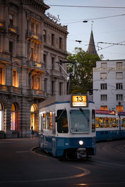 Zurich tram passing a modern hostel on a city street