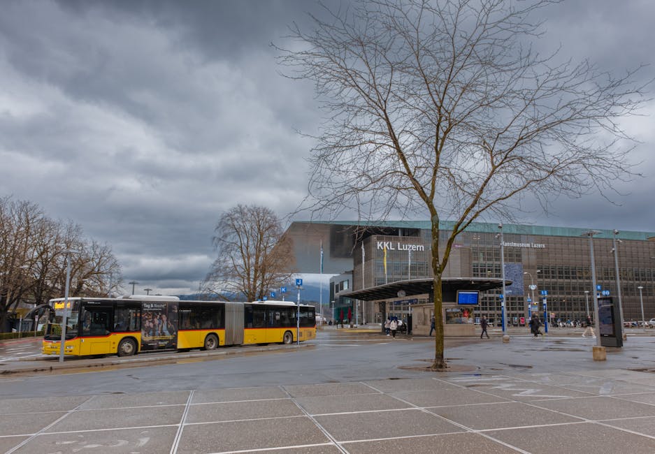 City bus at Bahnhofplatz stop in Lucerne with passengers boarding