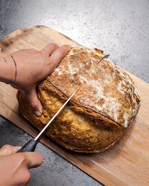 Artisan baker shaping a gluten-free loaf on a wooden board